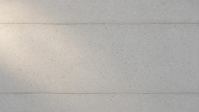A smooth wall of pale grey concrete fills the whole frame in this ...