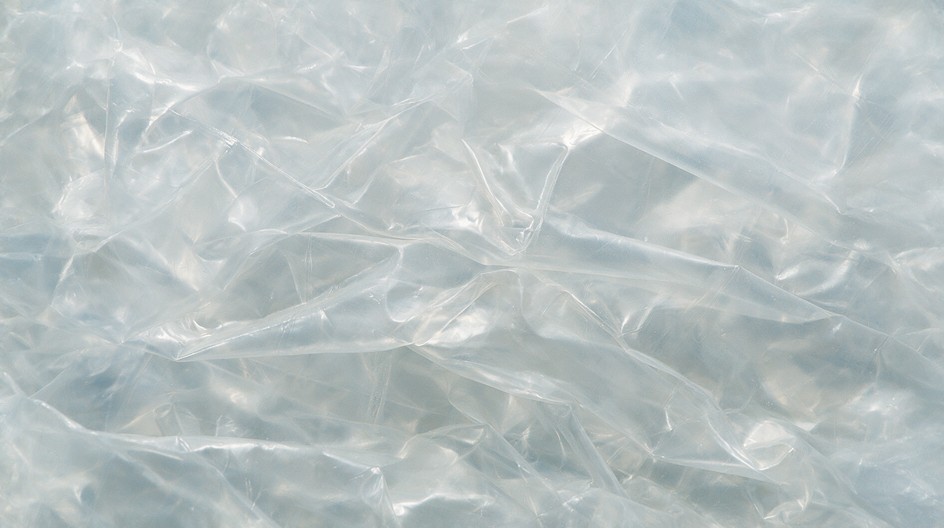 Layers of thin, see-through plastic film crumple together to fill the ...